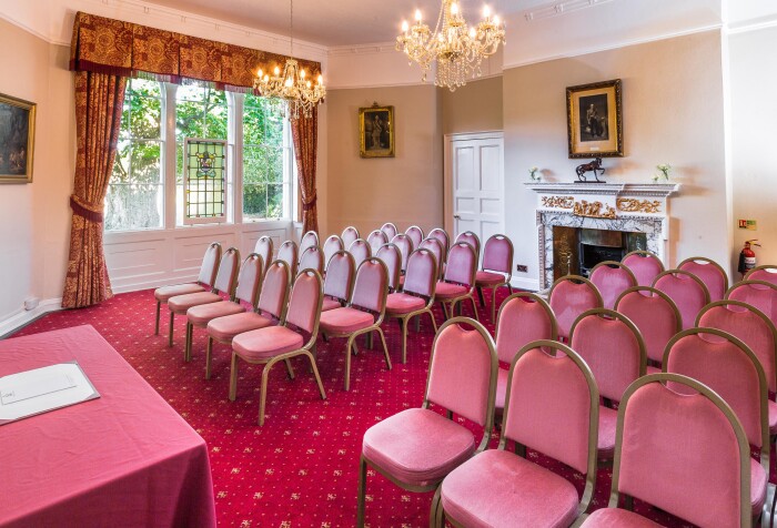 the Salisbury room set up theatre style with red velvet chairs facing the presenter's table