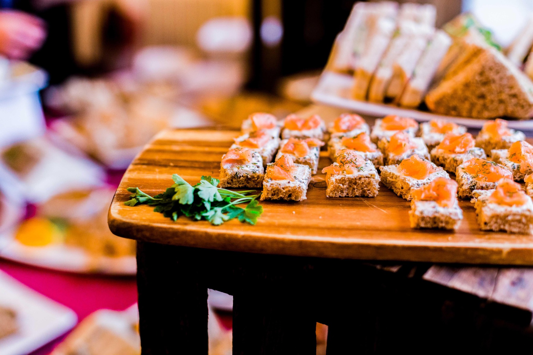 A close up of salmon canapes on a wooden table
