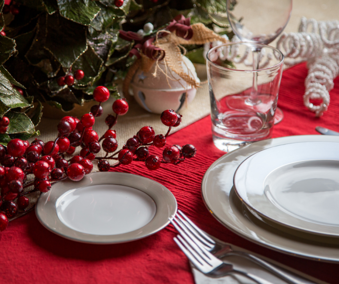 A table landscape of white china a red berries